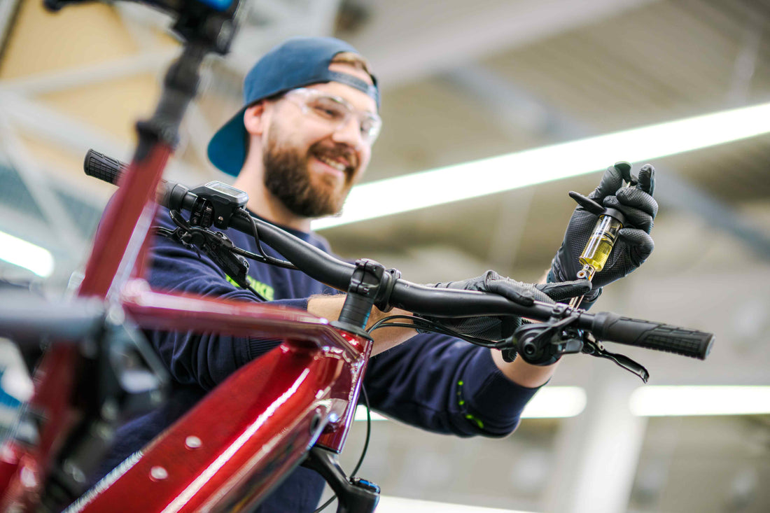 Mechaniker von Rebike in der Werkstatt beim Check eines E-Bike- Rahmens